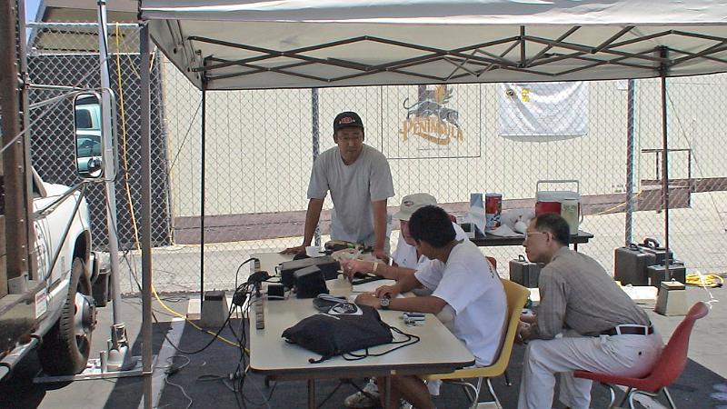 DSC04776.JPG - Curtis Watanabe KI6KUK standing, Mel Hughes K6SY operating at Get On the Air (GOTA) station with Christopher Sue KI6DDJ (Scout Troop 586) , and Scout Troop visitor