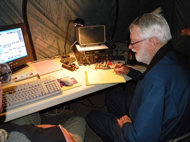 028.JPG - Homer Meek, K6HKT, operating CW overnight with Bill Pohlmann, WB6SIK (left), and Dan Colburn, W6DC (behind Homer).