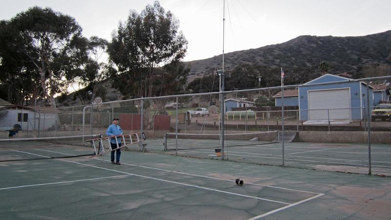 IMG_0081.JPG - Ray N6HE and Diana AI6DF assemble the tri-band fan dipole over the tennis courts next to the Fire Station