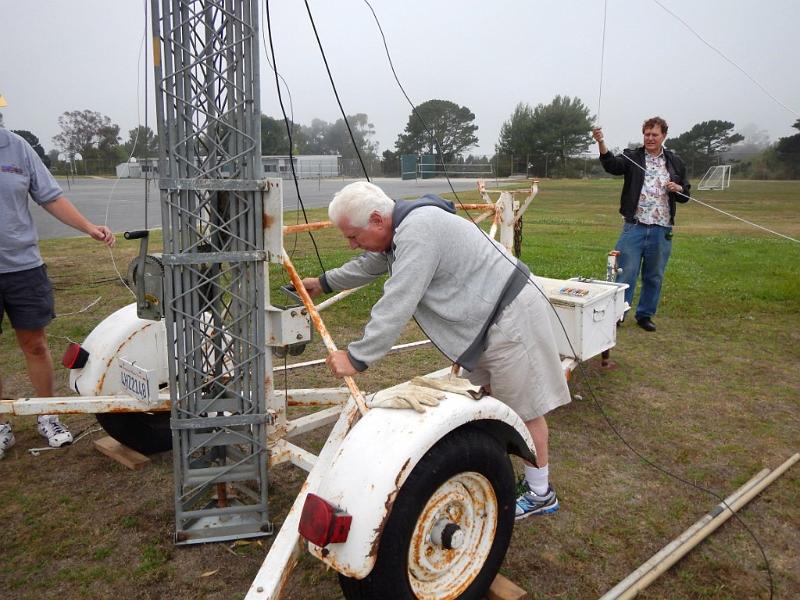 040a.jpg - Walt, K1DFO, checks the horizontal to vertical rise of our tower.