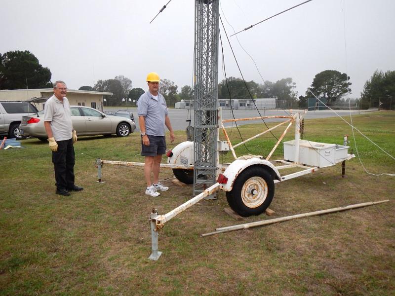 041a.jpg - Jerry, NG6R, and Peter, KE6JPM, examine tower trailer prior to full raising.